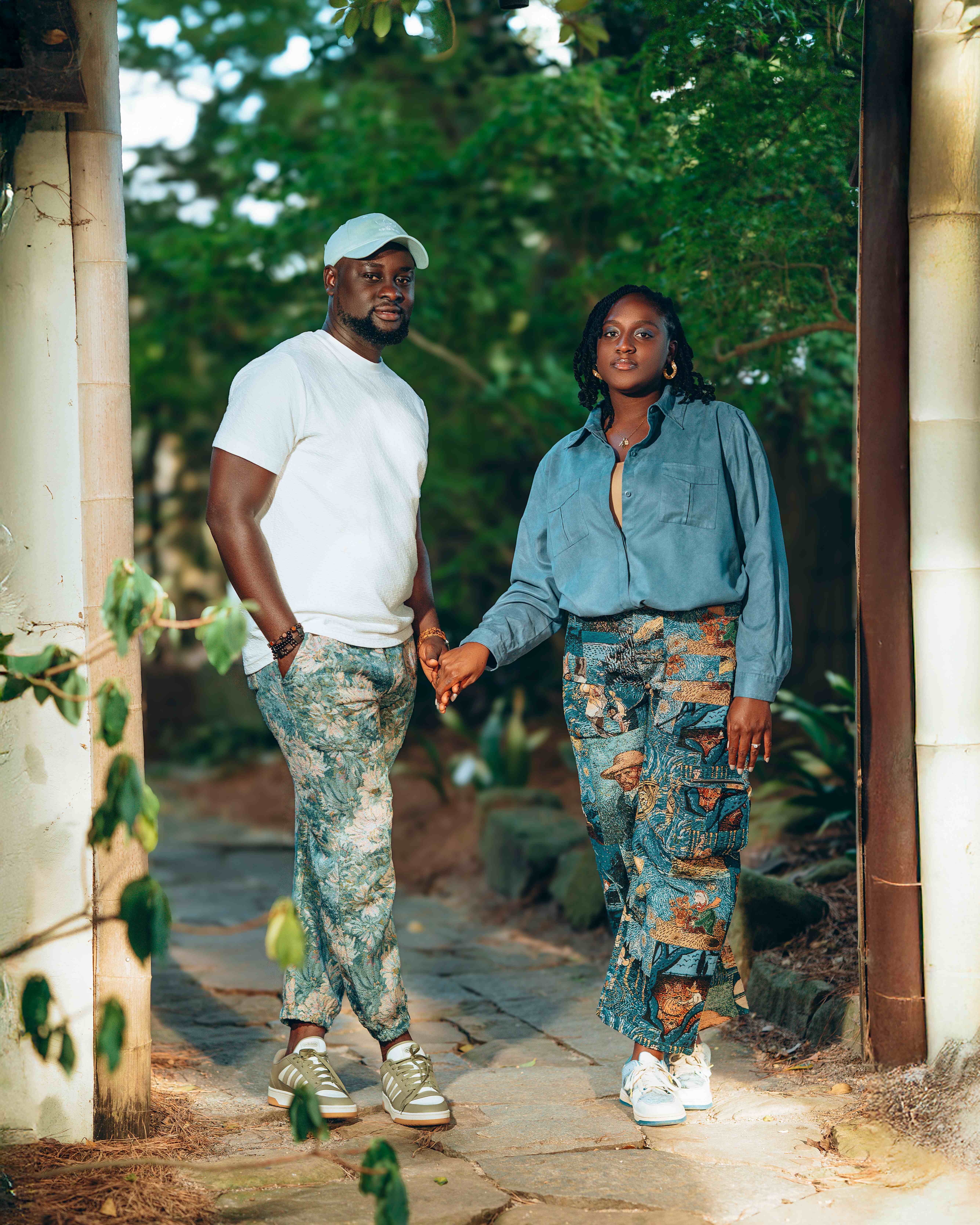 Couple holding hands in garden pathway