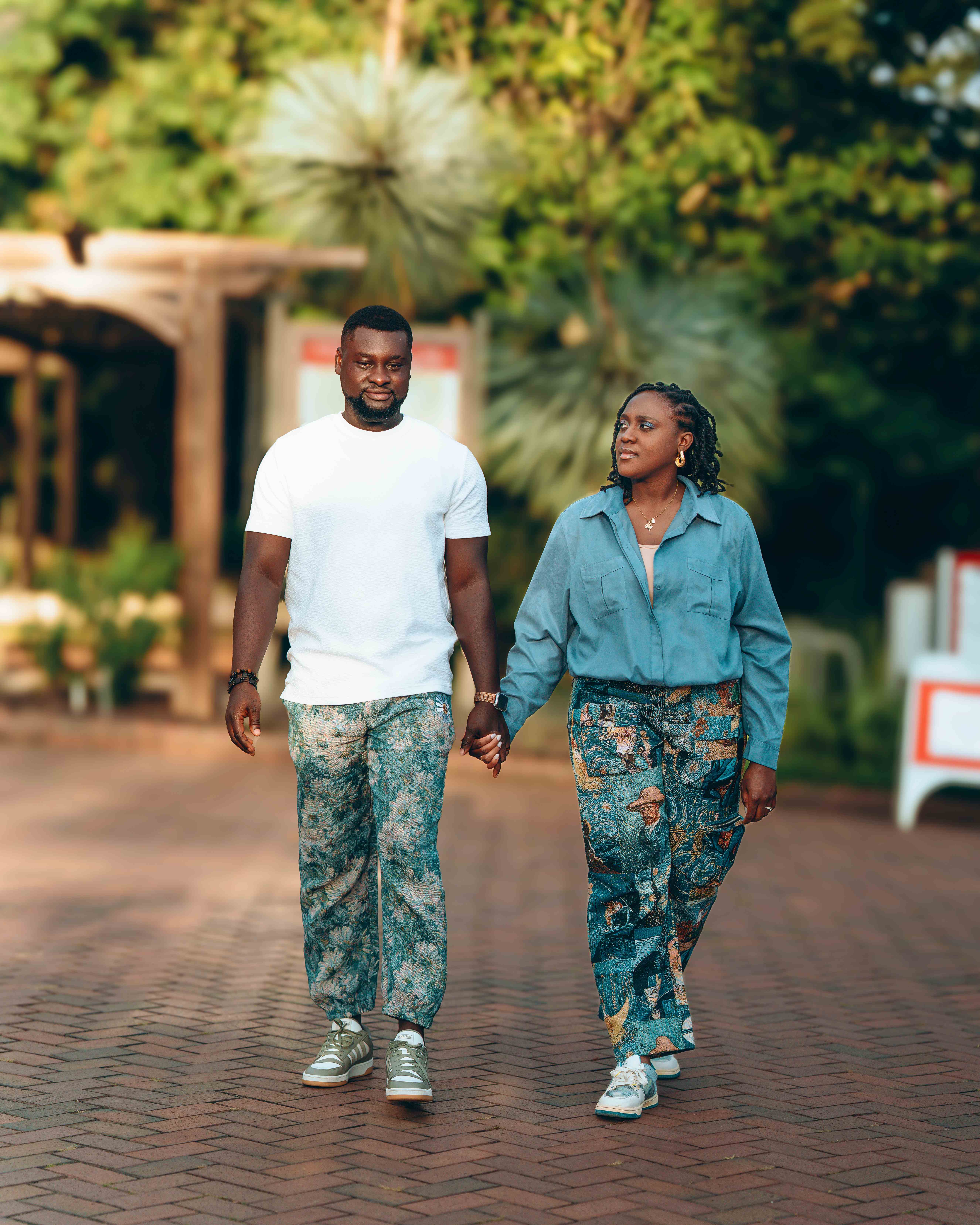 Couple walking together on brick pathway